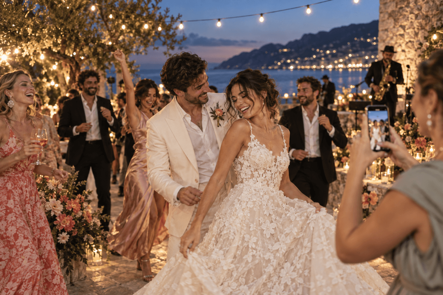 Newlyweds dancing while a guest captures the moment on a phone